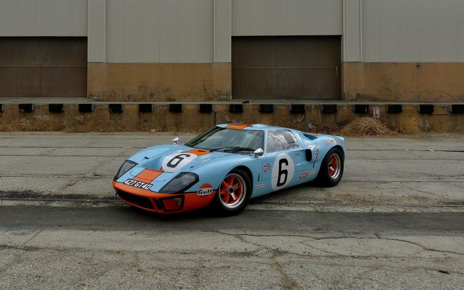 Gulf-livery Ford GT40 photographed from above in an industrial lot
