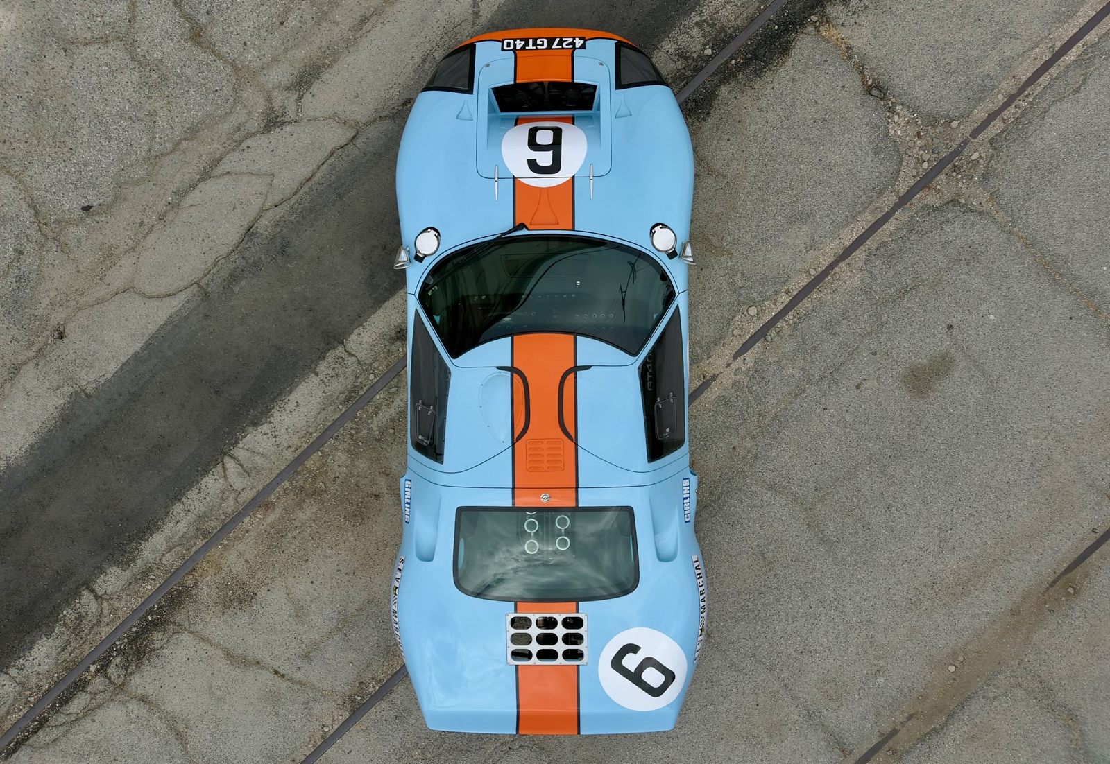 Top-down aerial view of a Gulf-livery Ford GT40, light blue with an orange stripe